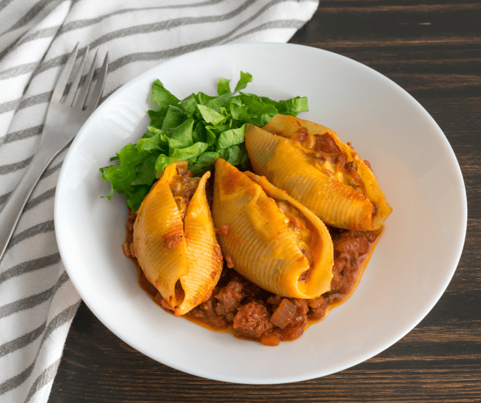 Golden-baked chicken stuffed shells topped with melted cheese and fresh parsley.